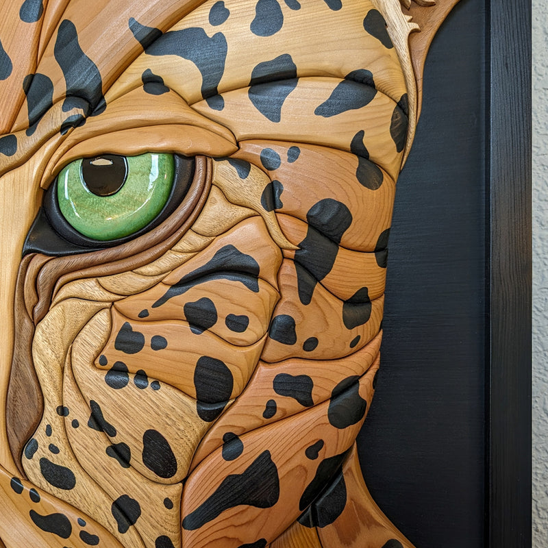 Intricate detailing of jaguar wood sculpture by Alex Jepson, showcasing craftsmanship and high-quality carving techniques.