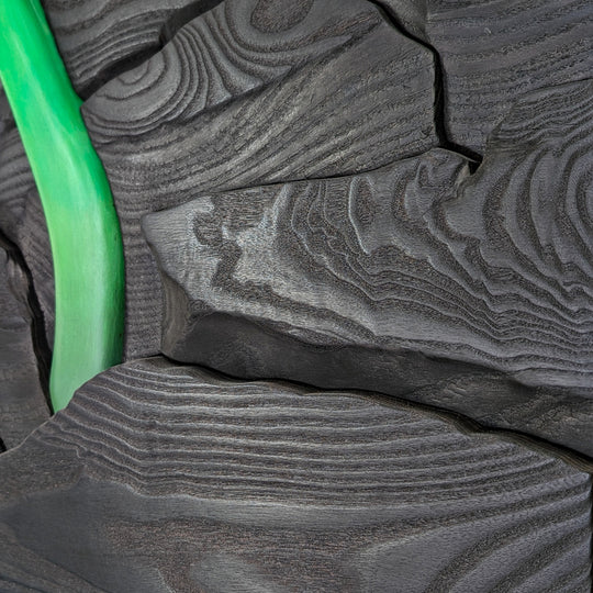 Close-up of the carved detail on Rebirth wood sculpture by Alex Jepson, emphasizing the precision and high-quality materials used to create this nature-inspired art.